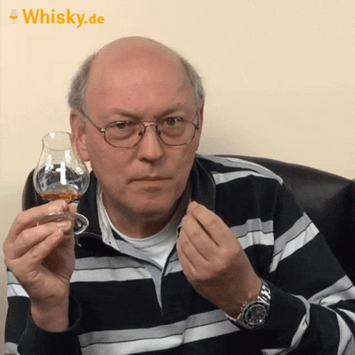 Man Holding Whisky In Front Of Whisky.de Banner GIF