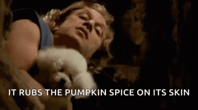 Man Holding White Dog It Rubs The Pumpkin Spice On Its Skin GIF
