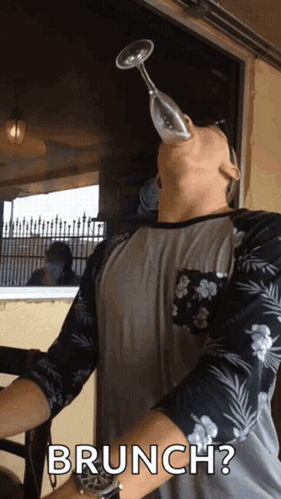 Man Holding Wine Glass In Mouth GIF