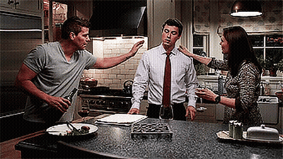 Man Holding Wine Talking To Woman And Man GIF