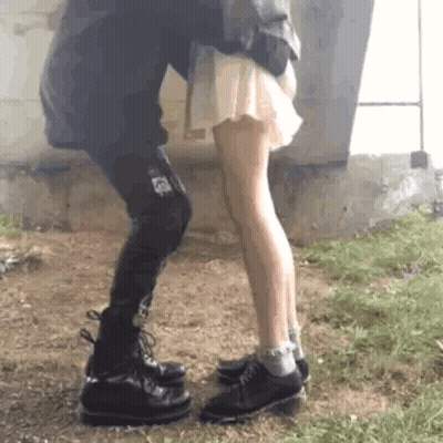 Man Holding Woman and Kissing Her Cheek