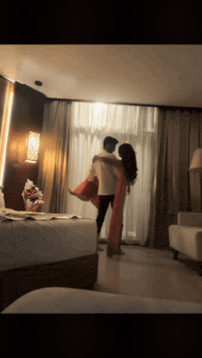 Man Holding Woman In Arms In Room GIF
