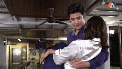 Man Holding Woman In Arms Under Ceiling Fan GIF