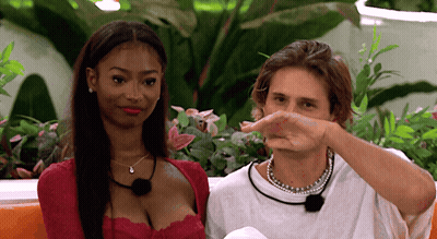 Man Holding Woman In Front Of Pink Wall GIF