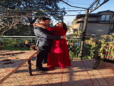 Man Holding Woman In Red Dress GIF