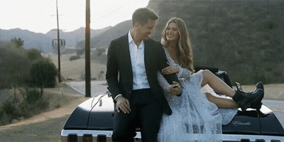 Man Holding Woman On Back Of Car GIF