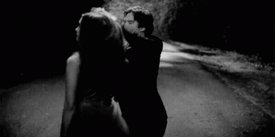 Man Holding Woman's Hair While Dancing On Road GIF