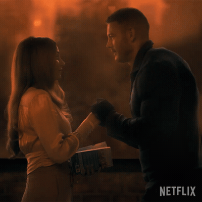 Man Holding Woman's Hand Netflix Sign GIF