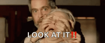Man Holding Woman's Mouth Saying Look At It GIF