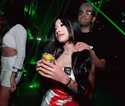 Man Holding Woman's Shoulders While She Holds Yellow Coke Can GIF