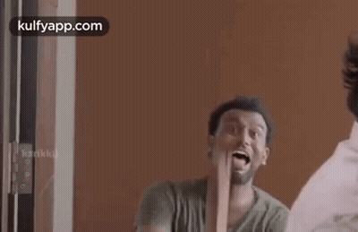 Man Holding Wood In Front Of Mirror GIF