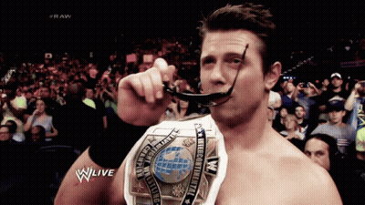 Man Holding World Wrestling Championship GIF