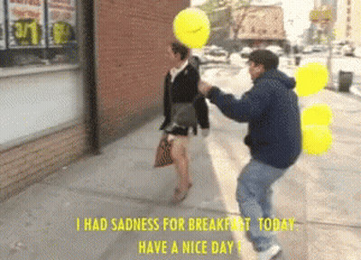 Man Holding Yellow Balloon Over Woman With Caption I Had Sadness For Breakfast Today GIF