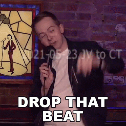 Man Holds Microphone And Says Drop That Beat GIF