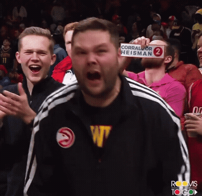 Man Holds Sign Saying Corral For Heisman GIF