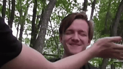 Man Hugged By Woman In Woods Smiling GIF