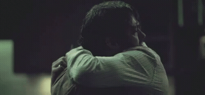 Man Hugging Another Man Holding Head Dark Room GIF
