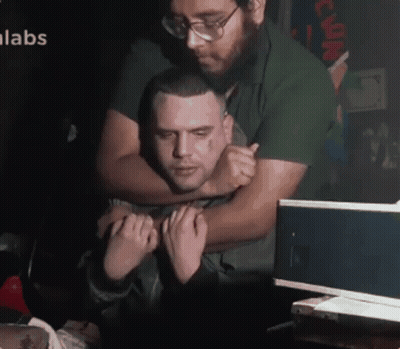Man Hugging Another Man With Labs GIF