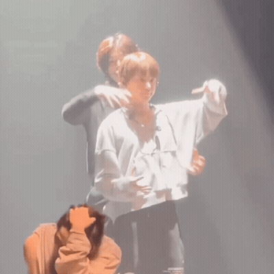 Man Hugging Another On Stage GIF