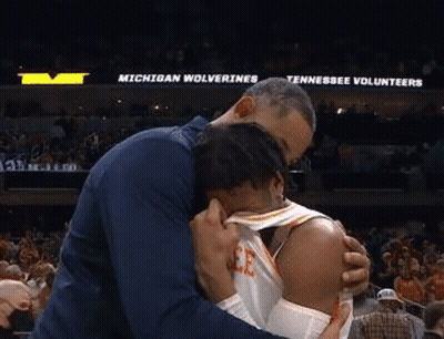Man Hugging Basketball Player In Stadium GIF