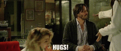 Man Hugging Woman At Table GIF