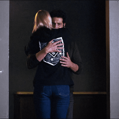 Man Hugging Woman In Black Skull Shirt GIF