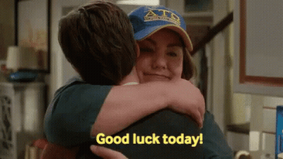 Man Hugging Woman in Blue Hat