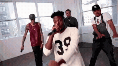Man In 39 Shirt Singing While Men Dance GIF