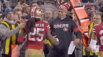 Man In 49Ers Sweatshirt Shaking Hands With Football Player GIF