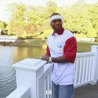 Man In 50 Cent Shirt On Railing Overlooking Lake GIF