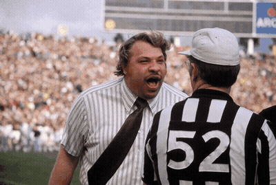 Man In 52 Shirt Talking To Another GIF