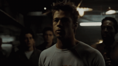 Man In A Shirt In Dark Room GIF