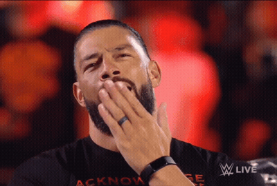 Man In Acknowlege Shirt Covering Mouth GIF