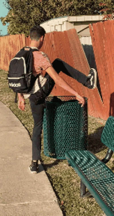 Man In Adidas Backpack Stretching Leg By Trash Can GIF