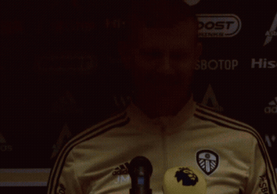 Man In Adidas Jacket In Front Of Boost Drinks Sign GIF