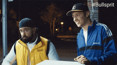 Man In Adidas Jacket Talking To Man In Yellow Vest GIF