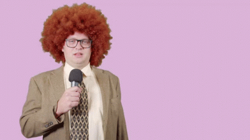 Man In Afro Wig Holding Microphone With Lets Check It Out Behind GIF