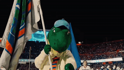 Man In Aggies Shirt In Front Of Scoreboard During Football Game GIF