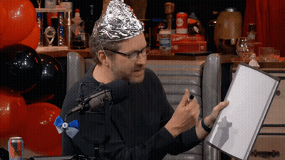 Man In Aluminum Foil Hat Holding Book GIF