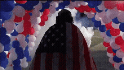 Man In American Flag Cape With Red White Blue Balloons GIF