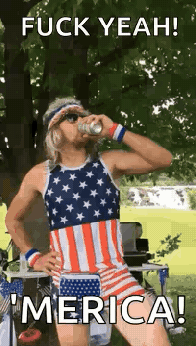 Man In American Flag Outfit Drinking Beer In Park GIF