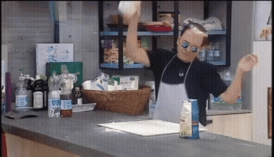 Man In Apron And Sunglasses Throwing A Ball GIF