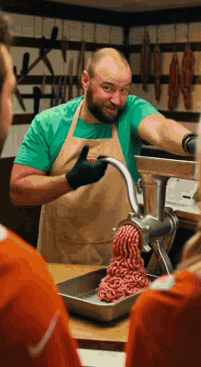 Man In Apron Grinding Meat GIF