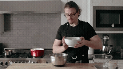 Man In Apron Holding Bowl GIF