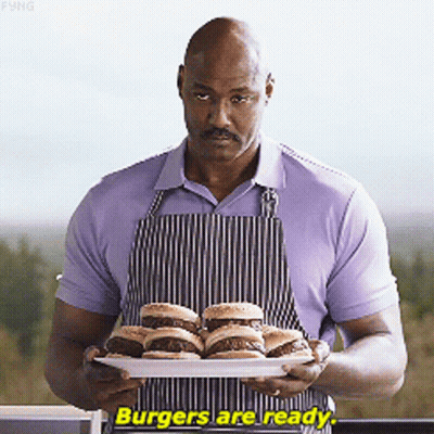 Man In Apron Holding Hamburgers Says Burgers Are Ready GIF