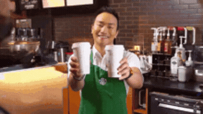Man In Apron Holding Two Cups Of Coffee GIF