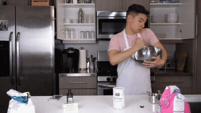 Man In Apron Mixing With Baking Powder GIF