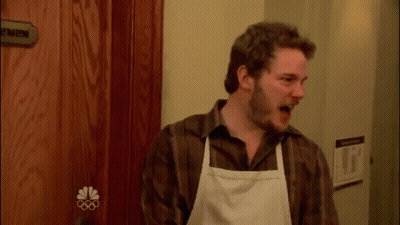 Man In Apron Standing Before Men Door GIF