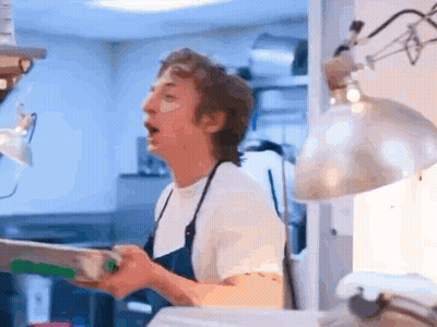 Man In Apron Standing In Kitchen GIF