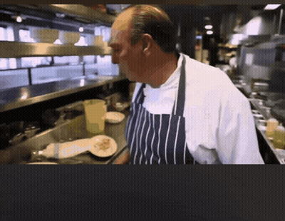 Man In Apron Standing In Kitchen GIF